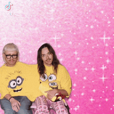 two men wearing matching yellow shirts with minions on them