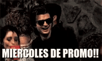 a man wearing sunglasses is surrounded by people and says miercoles de promo !!