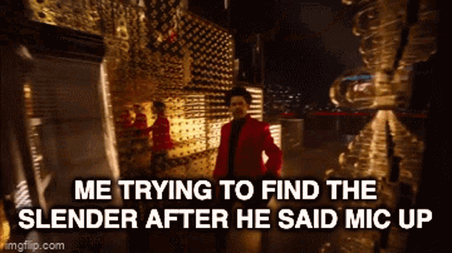 a man in a red jacket is standing in front of a wall with the words me trying to find the slender after he said mic up