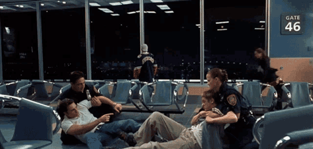 a group of people are fighting in front of a gate 46 sign