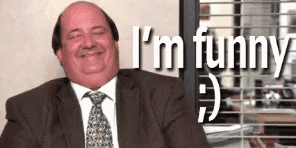a man in a suit and tie is smiling while sitting at a desk .