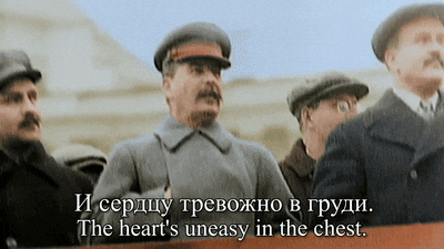 a man stands in front of a sign that says " the heart 's uneasy in the chest .. "