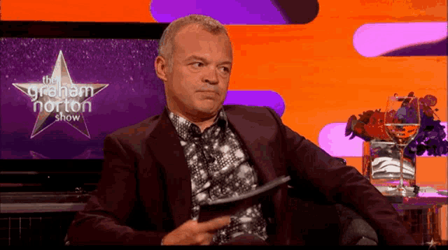 a man is sitting in front of a graham norton show
