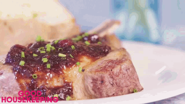 a close up of a piece of meat on a white plate with the words good housekeeping written on it