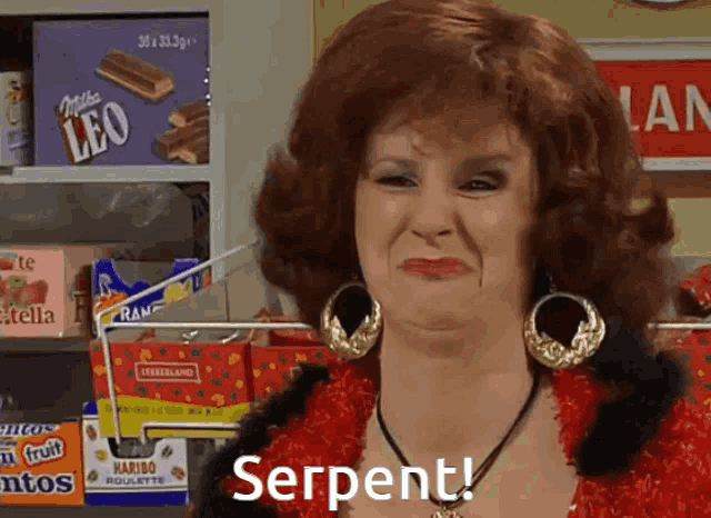 a woman in a red dress says serpent in front of a shelf of candy
