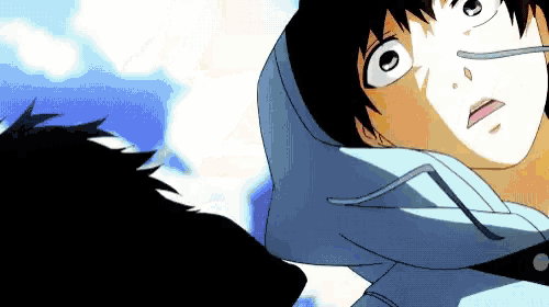 a man in a blue hoodie is looking up at something