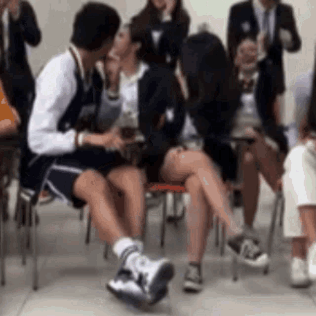 a man and a woman are kissing in a crowd of people .