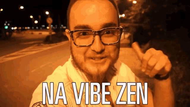 a man wearing glasses and a shirt that says na vibe zen on it