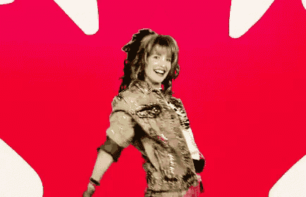 a woman is dancing in front of a canadian maple leaf .