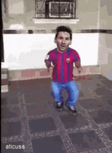 a man in a striped shirt is dancing in a room