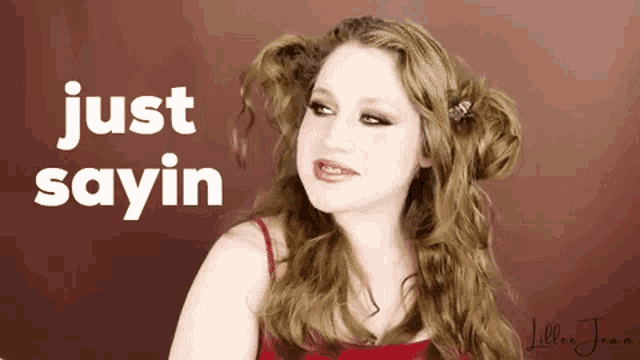a woman says just sayin in front of a brown background