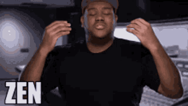 a man with his eyes closed is wearing a black shirt and a hat and the word zen is on the bottom