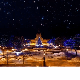 a large building is lit up with christmas lights