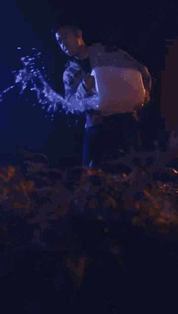 a man in a camo jacket is holding a torch in his hand