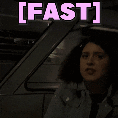 a woman is sitting in a car with the words fast behind her