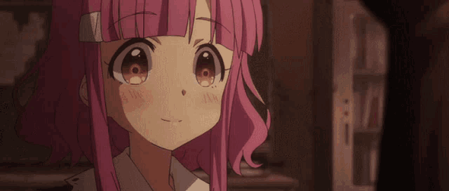 a girl with pink hair is smiling and winking at the camera