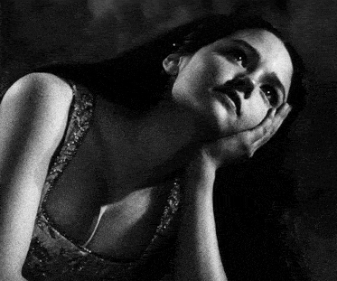 a black and white photo of a woman with long hair