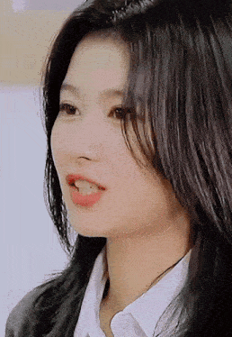 a close up of a woman 's face with dark hair