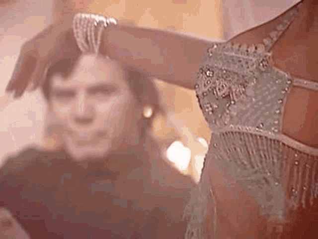 a man is holding a woman 's arm while she dances .