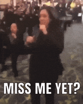 a woman is dancing in a room with the words miss me yet