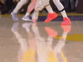a basketball player wearing a pair of red shoes
