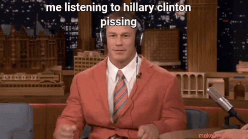 a man wearing headphones and a red suit says " me listening to hillary clinton "
