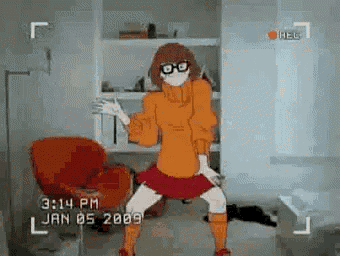 a video of velma from scooby doo dancing in a living room .