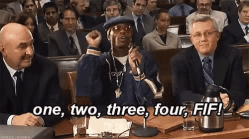 a man is giving a speech in front of a crowd of people and says one , two , three , four , fif