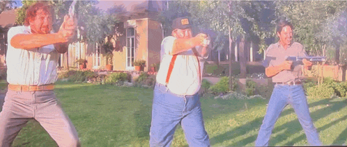 three men are holding guns in a yard and one has a hat with the letter b on it