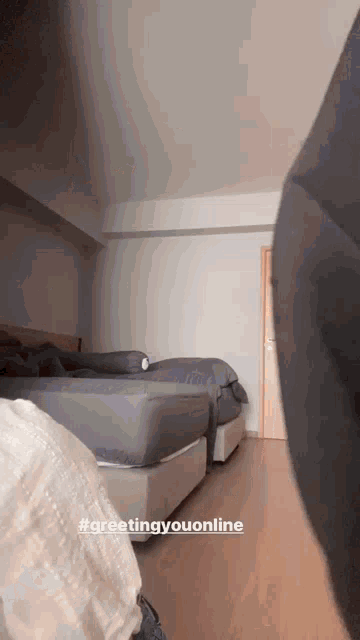 a bedroom with two beds and the words #greetingyouonline on the bottom right