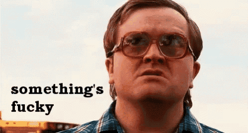 a man wearing glasses and a plaid shirt is making a funny face and says something 's fucky .