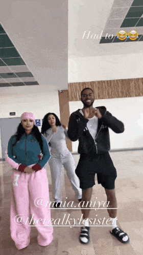 a man and two women are dancing in a room with the words " had to " written above them