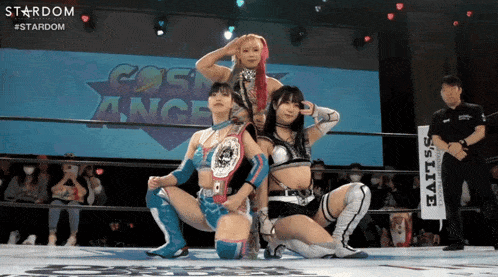 three women in a wrestling ring with a sign that says stardom on it
