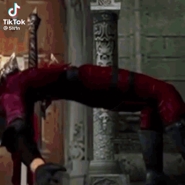 a person in a red devil costume is doing a handstand