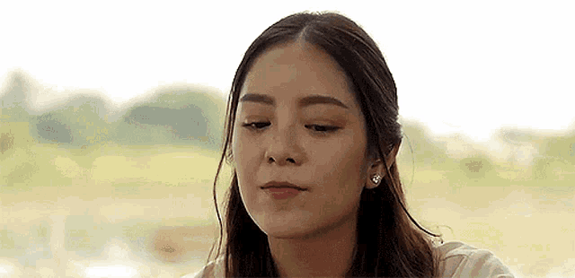 a woman is sitting at a table with her eyes closed .