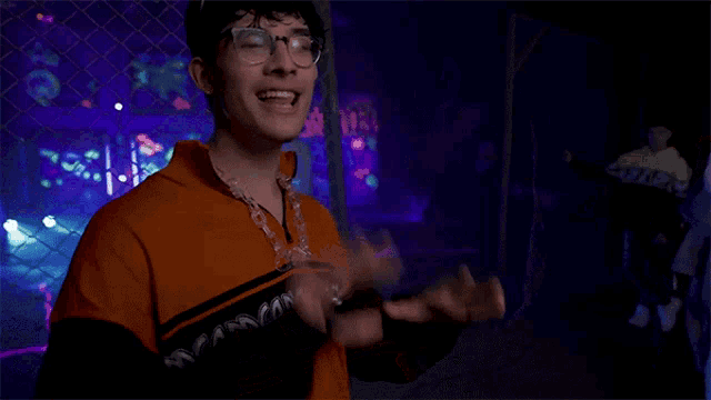 a young man wearing glasses and an orange shirt with the word insane on it