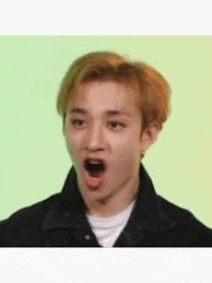 a young man with a surprised look on his face .