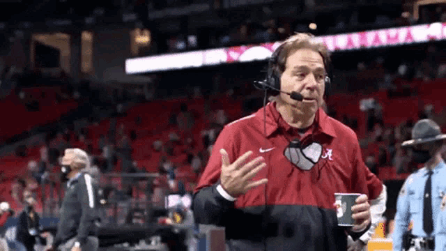 a man wearing headphones and a jacket that says alabama on it