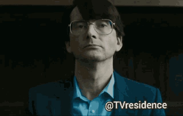 a man wearing glasses has the words not guilty above his face
