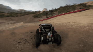 a buggy with the number 179 on the back is driving down a dirt road