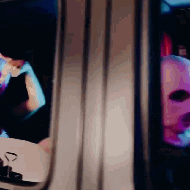 a reflection of a person in a mirror with a purple face