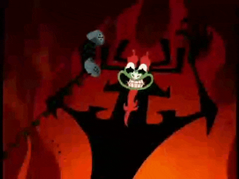 a cartoon character with a green face is standing in the middle of a red cave .