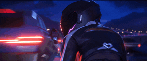 a person in a motorcycle helmet is holding a pink heart