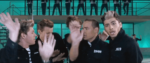 a group of young men are standing in front of a prison cell and one of them has the number 29809 on his shirt