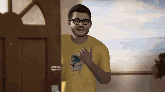 a man wearing glasses and a yellow shirt with a game boy on it stands in front of a door