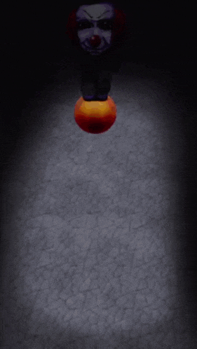 a clown with a purple face and red nose is standing on a ball