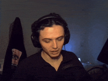 a man wearing headphones is making a funny face with his tongue out