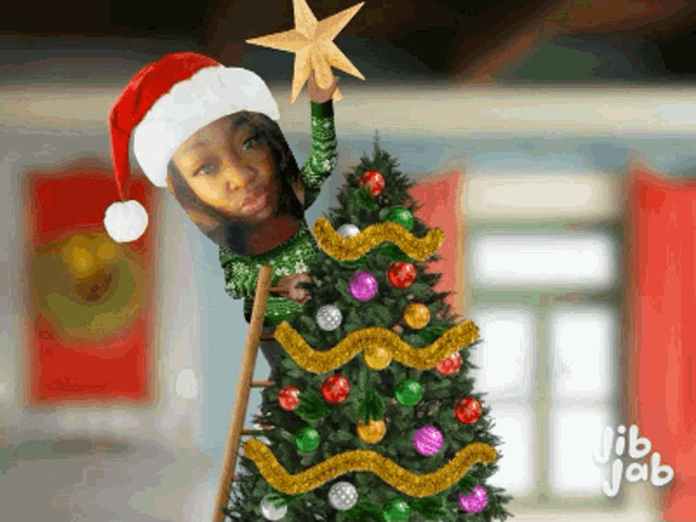 a girl wearing a santa hat holds a star on top of a christmas tree