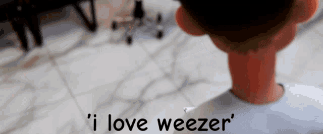 a cartoon character says ' i love weezer ' on the bottom