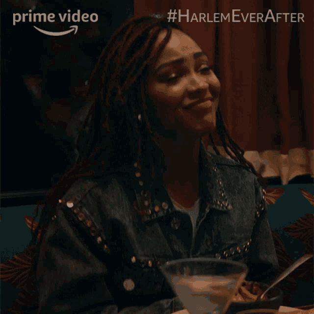 a woman with dreadlocks sits at a table with a martini in front of her and the words harlem ever after above her